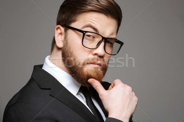 Közelkép portré töprengő fiatal üzletember öltöny Stock fotó © deandrobot