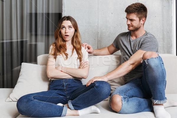Man trying to talk to his bored girlfriend Stock photo © deandrobot