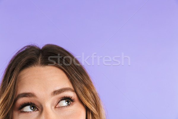Close up half face woman looking up at copy space Stock photo © deandrobot