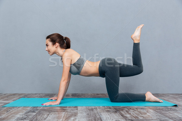 Young beautiful fitness girl doing yoga exercise Stock photo © deandrobot