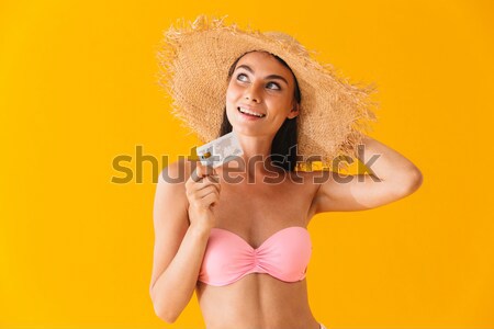 Smiling pretty nice beach girl using suntan cream Stock photo © deandrobot