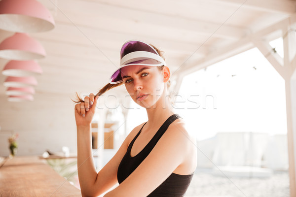 Young beautiful sports woman posing at beach cafe Stock photo © deandrobot