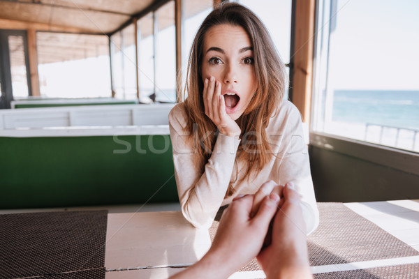 Surprised woman on date in cafe near the sea Stock photo © deandrobot