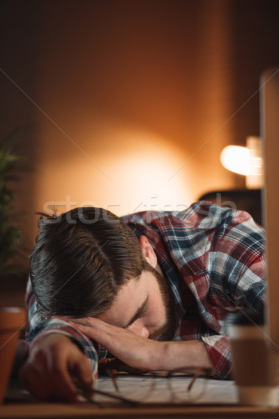 Tired bearded young designer sleeping in office late at night Stock photo © deandrobot