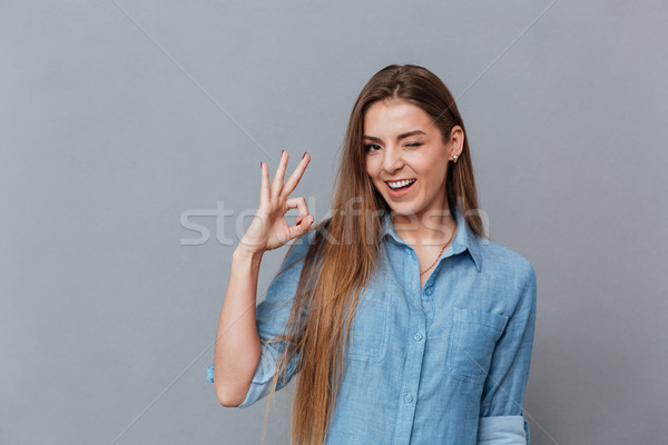 Woman in shirt showing ok sign Stock photo © deandrobot