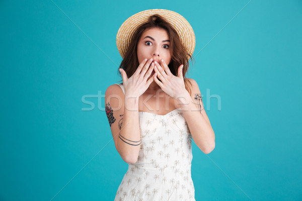 Summer girl covering mouth with hands and looking at camera Stock photo © deandrobot