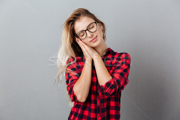 Beautiful young blonde woman showing sleep gesture Stock photo © deandrobot