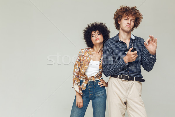 Serious retro loving couple standing and posing Stock photo © deandrobot