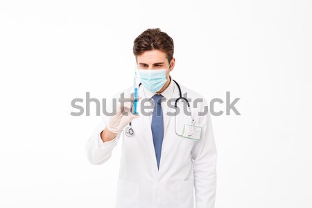 Close up portrait of a young male doctor Stock photo © deandrobot