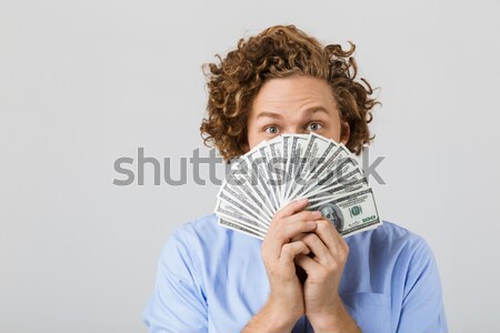 Surprised brunette woman in sweater hiding behind the money Stock photo © deandrobot