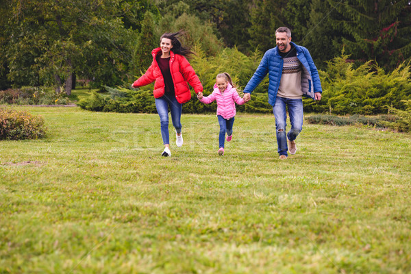 Young happy family of three spending fun time together Stock photo © deandrobot