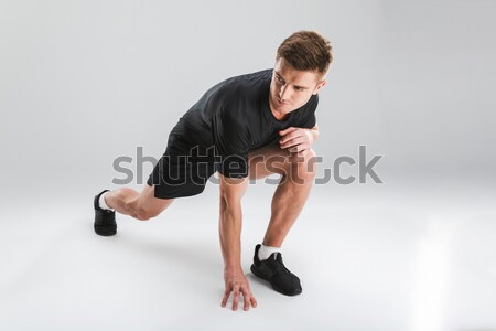 Full length portrait of a confident young half naked sportsman Stock photo © deandrobot