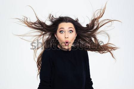 Portrait of an excited young woman with long hair Stock photo © deandrobot