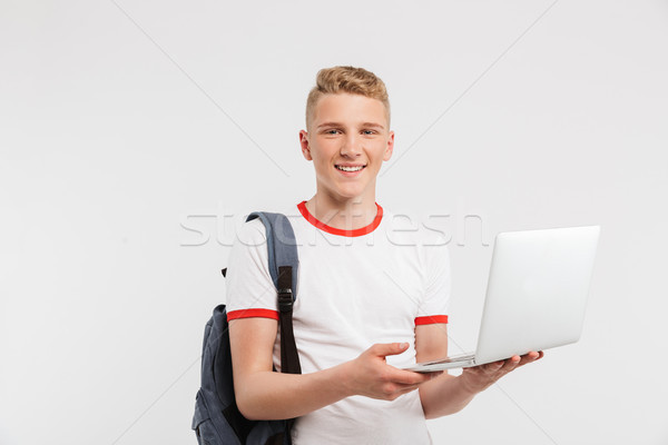 Image of teen man 16-18 years old wearing basic clothing and bac Stock photo © deandrobot
