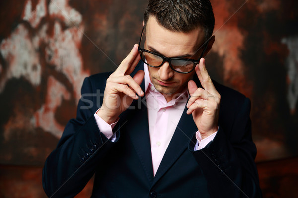 Cool fashion man in glasses standing over industrial background Stock photo © deandrobot