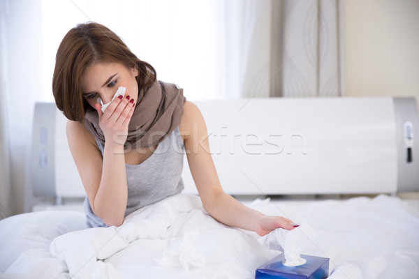 Portrait of a sick woman on the bed at home Stock photo © deandrobot