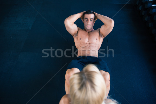 Muscular man doing abs exercise Stock photo © deandrobot