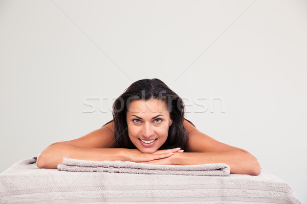 Woman lying on massage lounger Stock photo © deandrobot