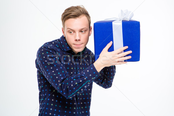 Amusing curious man trying to listen something inside present box Stock photo © deandrobot