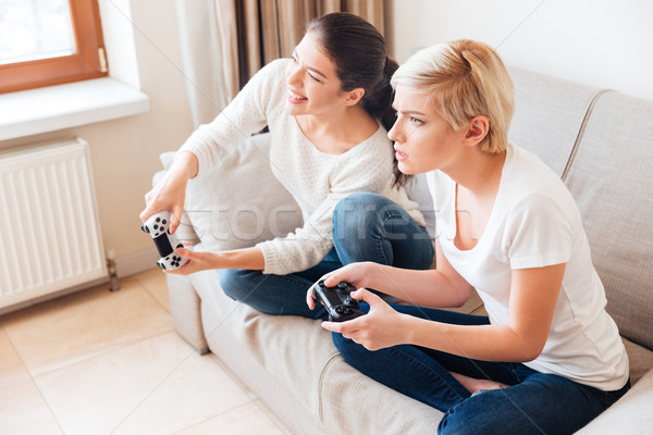Women playing video games Stock photo © deandrobot