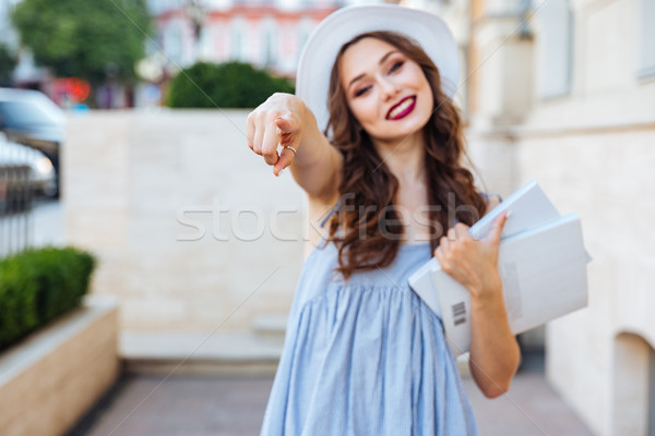 Young beautiful brunette woman pointing finger at you Stock photo © deandrobot