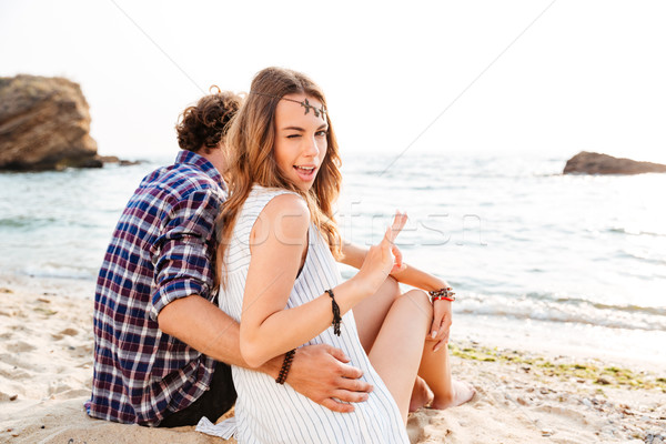 Femme séance copain plage [[stock_photo]] © deandrobot