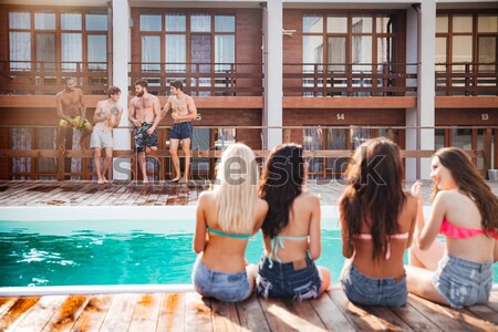 Handsome young smiling men having fun in swimming pool Stock photo © deandrobot