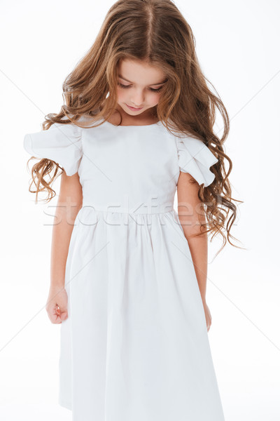 Triste bonitinho little girl em pé olhando para baixo longo Foto stock © deandrobot