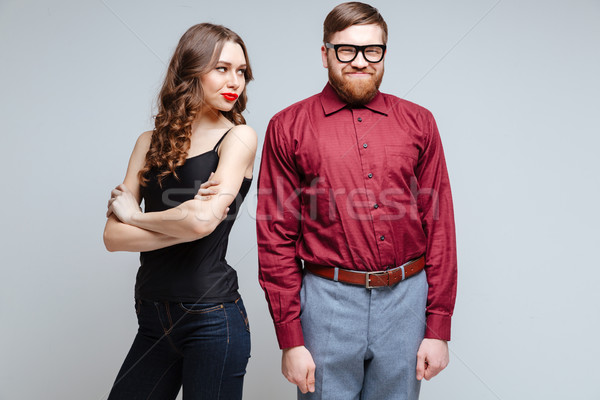 Beauty Displeased woman with smiling male nerd Stock photo © deandrobot