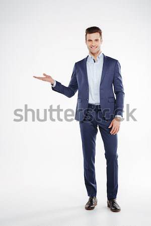 Full length portrait of man holding invisible copyspace on pound Stock photo © deandrobot
