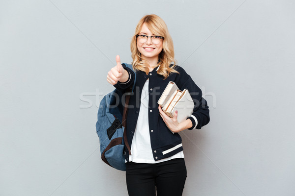 Woman student showing thumb up Stock photo © deandrobot