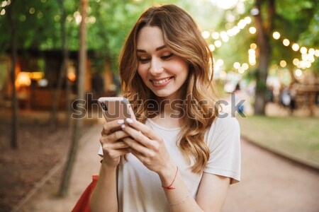 Portrait of young woman showing thumb up in the street. Stock photo © deandrobot