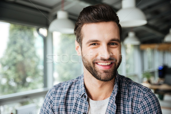 Happy man standing in office coworking Stock photo © deandrobot