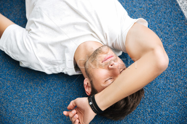 Exhausted sportsman finished his race and resting Stock photo © deandrobot