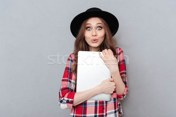 Mosolygó nő kockás póló tart laptop portré Stock fotó © deandrobot