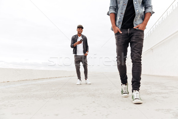 Homme regarder téléphone écouter musique photo [[stock_photo]] © deandrobot