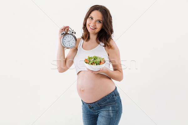 Foto stock: Sorridente · mulher · grávida · vitamina · salada · relógio