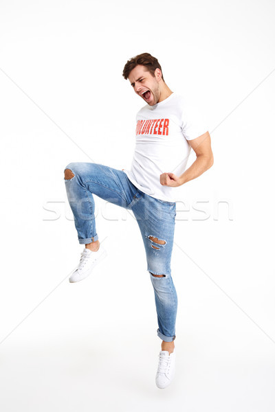 Full length portrait of a happy man in volunteer t-shirt Stock photo © deandrobot