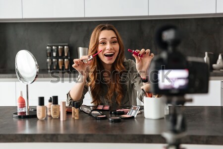 Satisfied young girl recording her video blog episode Stock photo © deandrobot