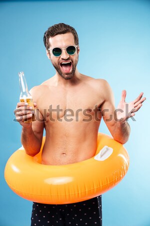 Happy man standing with rubber ring Stock photo © deandrobot