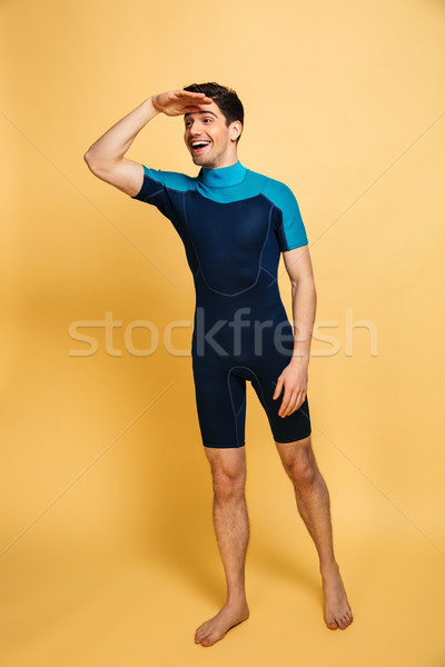 Full length portrait of a happy young man Stock photo © deandrobot