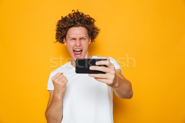 Derűs férfi barna haj sikít ököl elvesz Stock fotó © deandrobot
