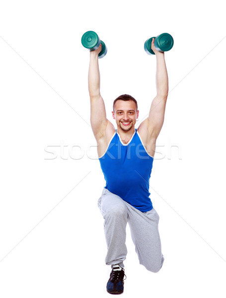 Sport man working out with dumbbells over white bakground Stock photo © deandrobot