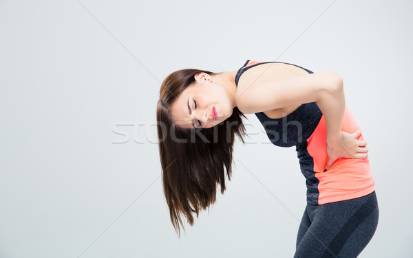 Fitnessz nő hátfájás szürke nő sport fitnessz Stock fotó © deandrobot