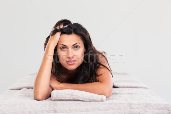 Attractive woman lying on massage lounger Stock photo © deandrobot