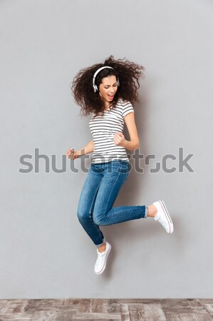 Smiling girl holding bottle with water Stock photo © deandrobot