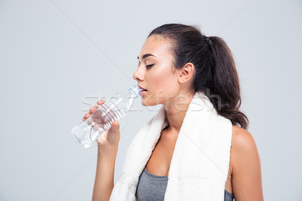 Fitness Frau Handtuch Trinkwasser Porträt isoliert weiß Stock foto © deandrobot