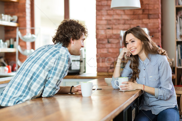 Young couple enjoying coffee in cafeteria Stock photo © deandrobot