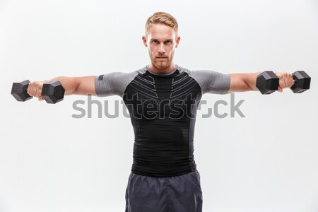 Confused young man with gun shrugging his shoulders Stock photo © deandrobot