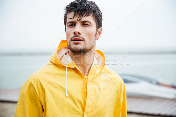 Közelkép portré matróz férfi citromsárga köpeny Stock fotó © deandrobot